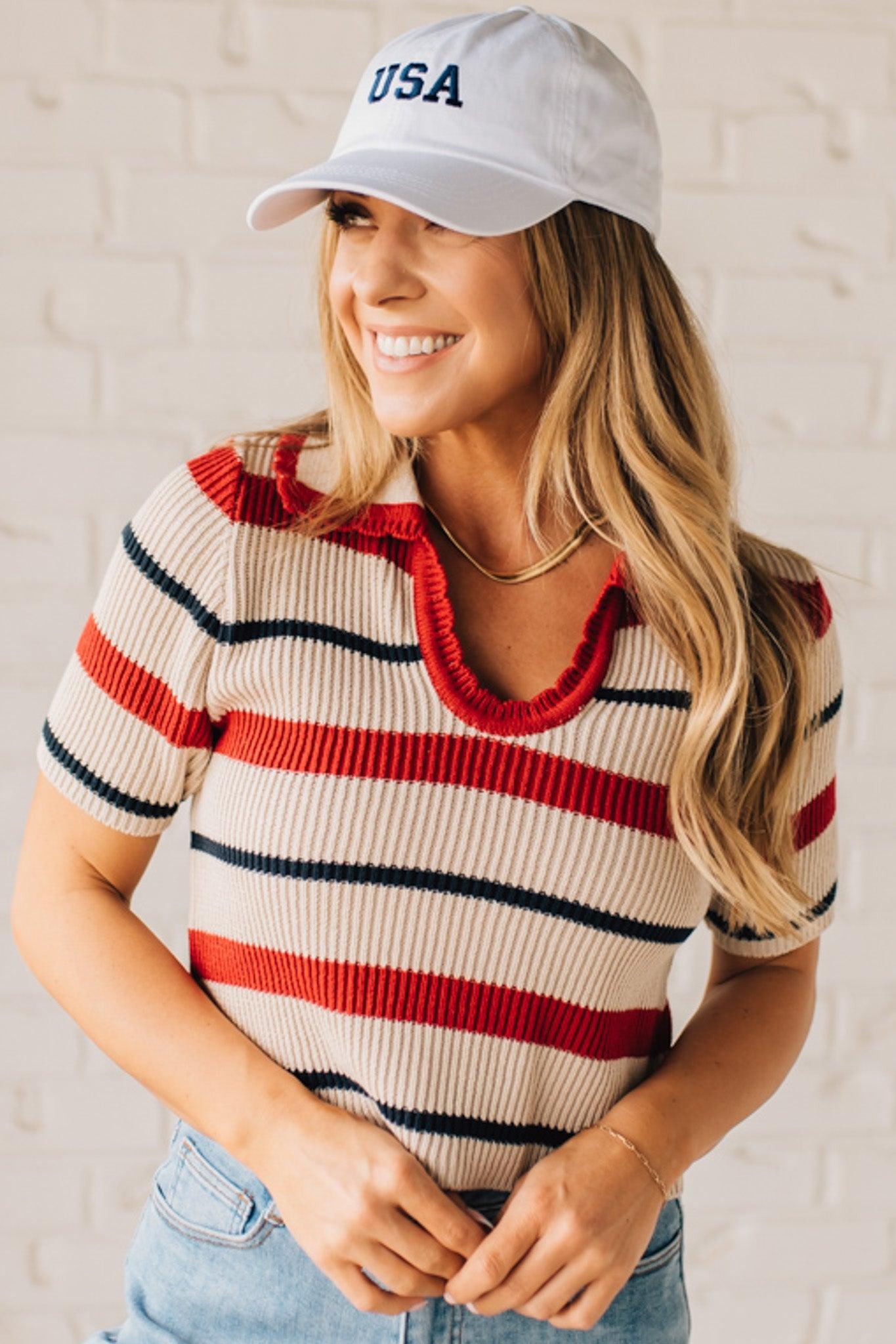 Blonde Woman in a White Hat Wearing a Striped Collared Short Sleeve Cropped Sweater