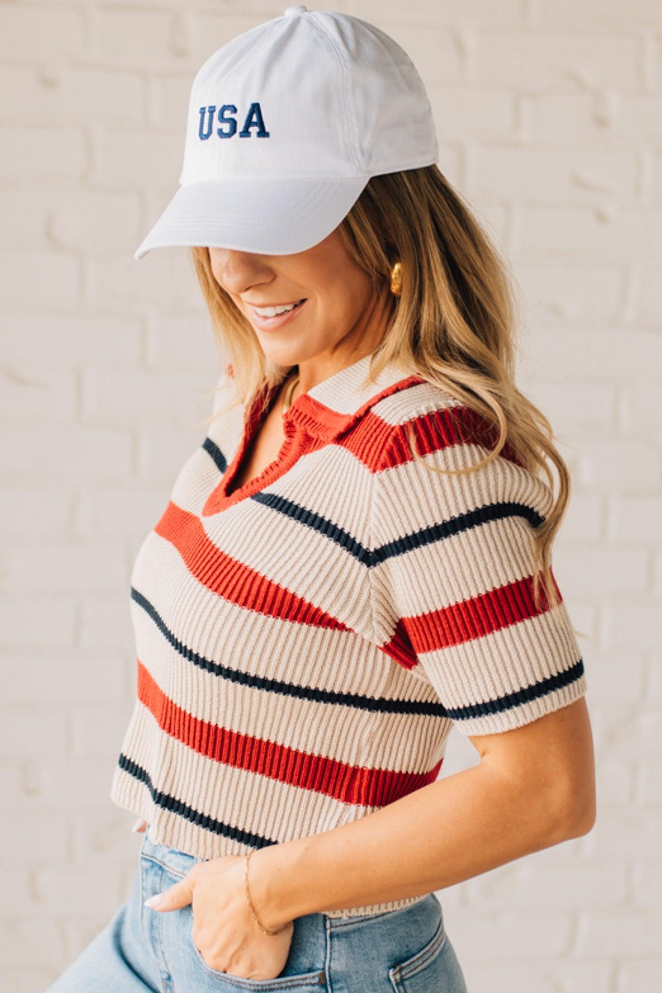 Blonde Woman in a White Hat Wearing a Striped Collared Short Sleeve Cropped Sweater