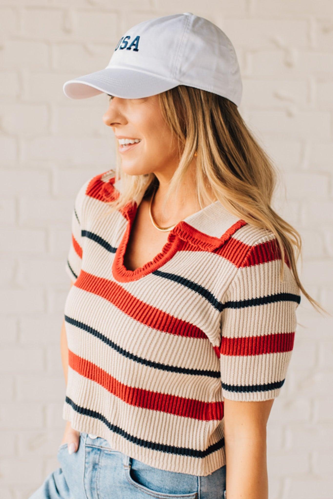 Blonde Woman in a White Hat Wearing a Striped Collared Short Sleeve Cropped Sweater