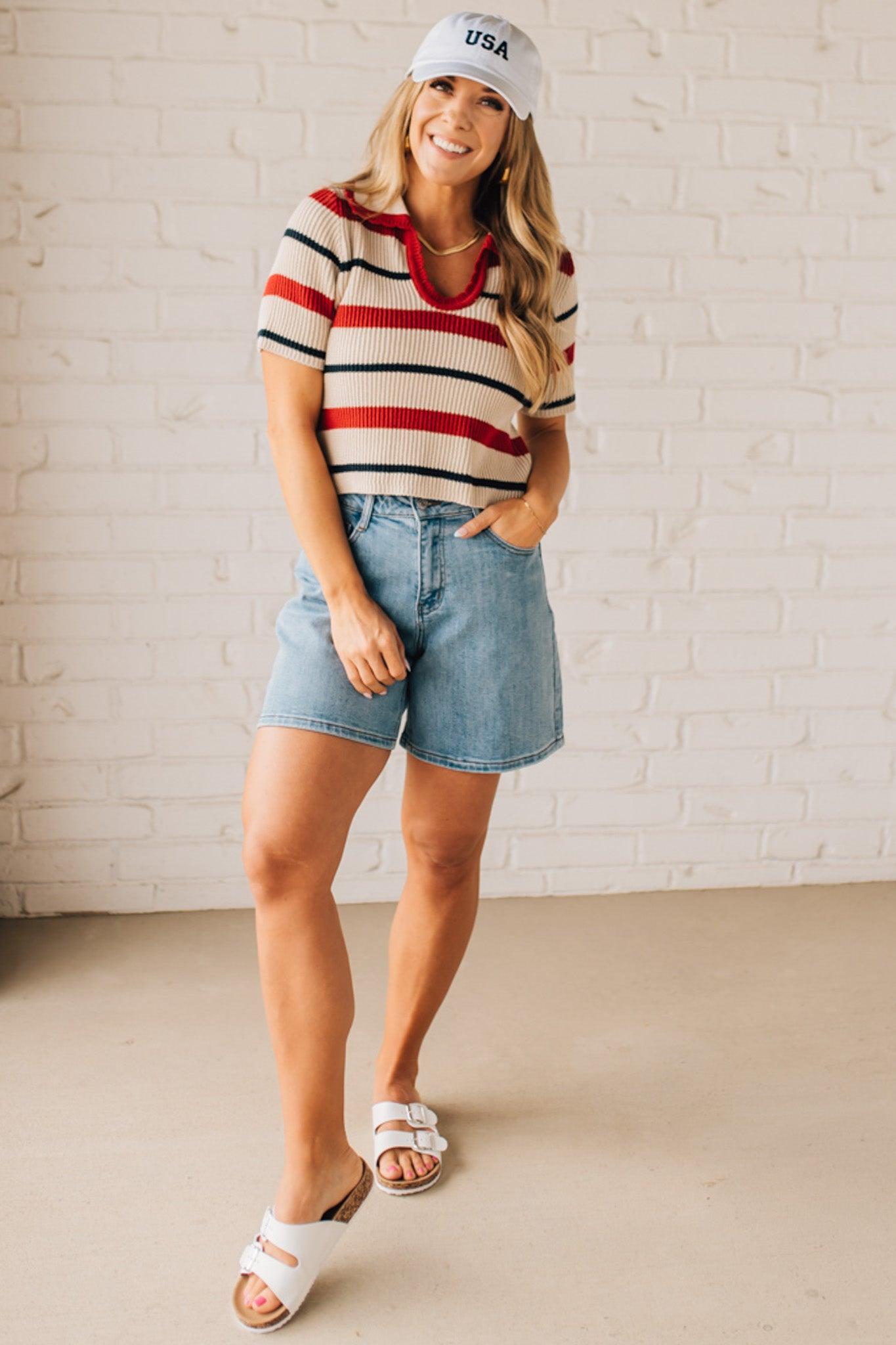 Blonde Woman in a White Hat Wearing a Striped Collared Short Sleeve Cropped Sweater