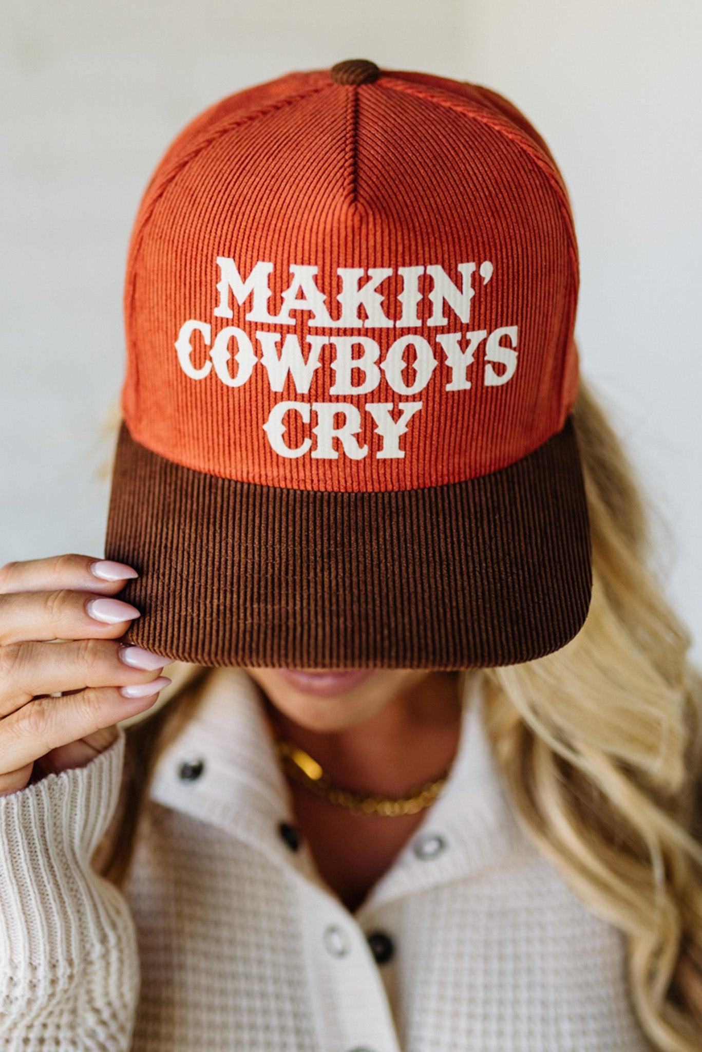 Person wearing a rust and brown cap with 'MAKIN' COWBOYS CRY' text.
