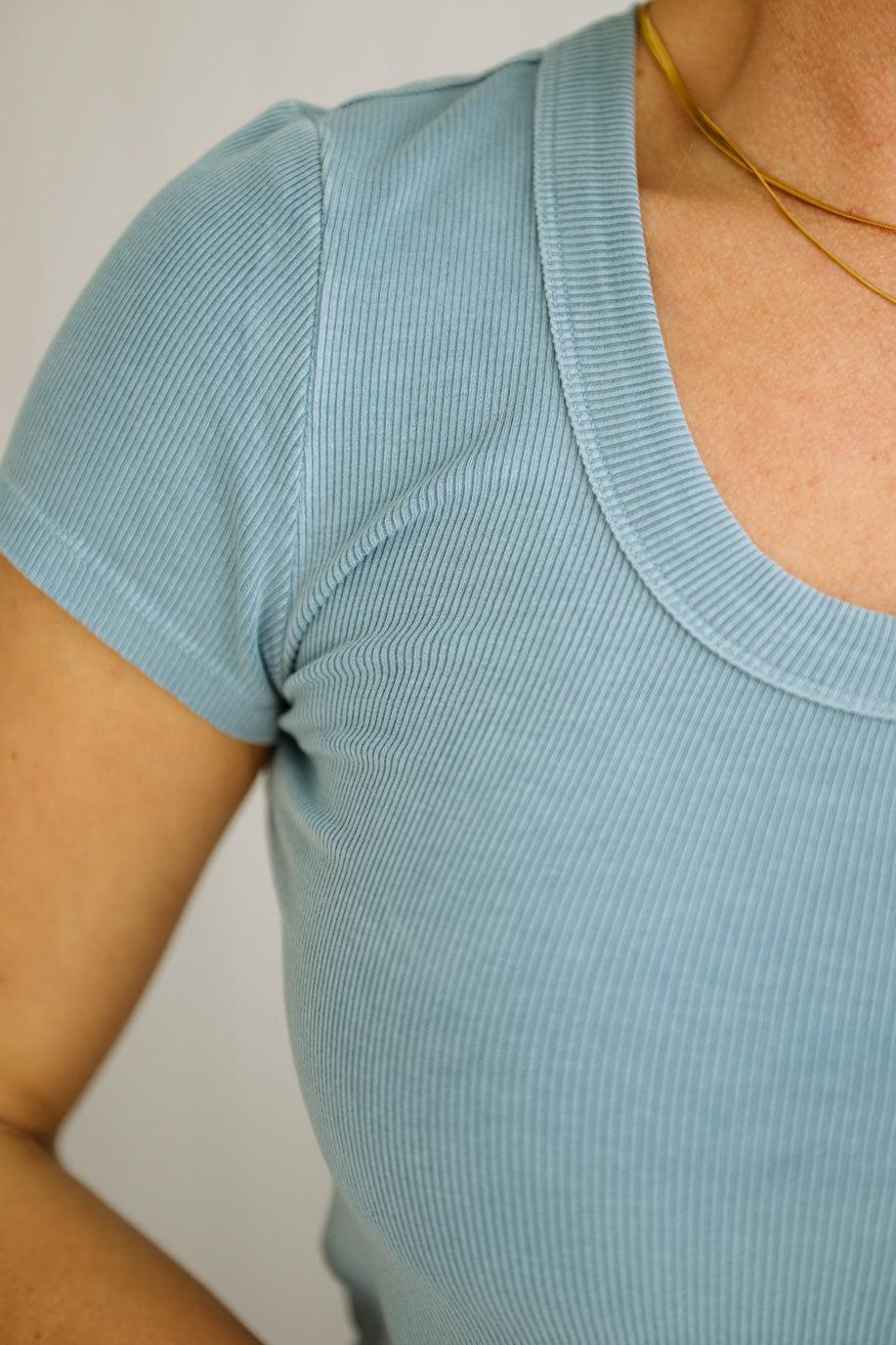 Light blue ribbed top worn by a person with a neutral background