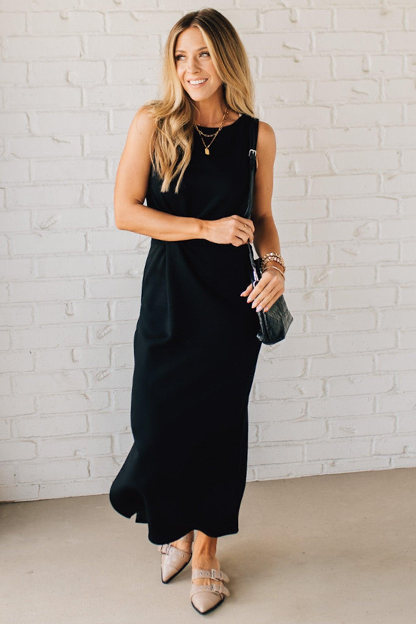 Blonde woman in a black dress with a Convertible Woven Crossbody Handbag in black vegan leather.