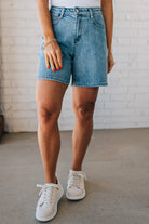 WOMAN WEARING STRETCH BLEND HIGH WAIST BERMUDA DENIM MOM SHORTS.