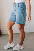 WOMAN WEARING STRETCH BLEND HIGH WAIST BERMUDA DENIM MOM SHORTS.