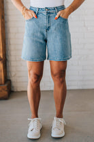 WOMAN WEARING STRETCH BLEND HIGH WAIST BERMUDA DENIM MOM SHORTS.