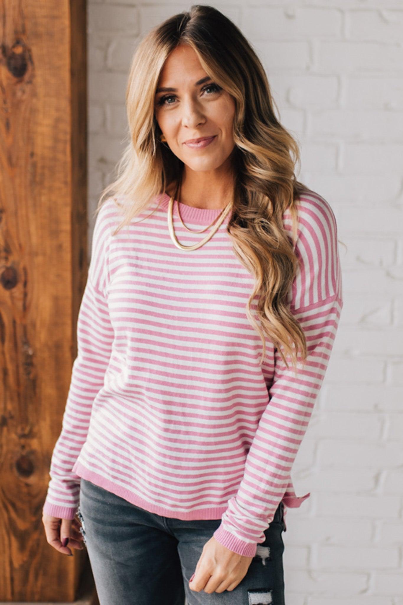 BLONDE WOMAN MODELING A LONG SLEEVE STRIPED LIGHTWEIGHT SWEATER WITH RIBBED SOLID COLORED NECKLINE AND SLEEVE CUFFS