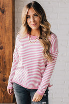 BLONDE WOMAN MODELING A LONG SLEEVE STRIPED LIGHTWEIGHT SWEATER WITH RIBBED SOLID COLORED NECKLINE AND SLEEVE CUFFS