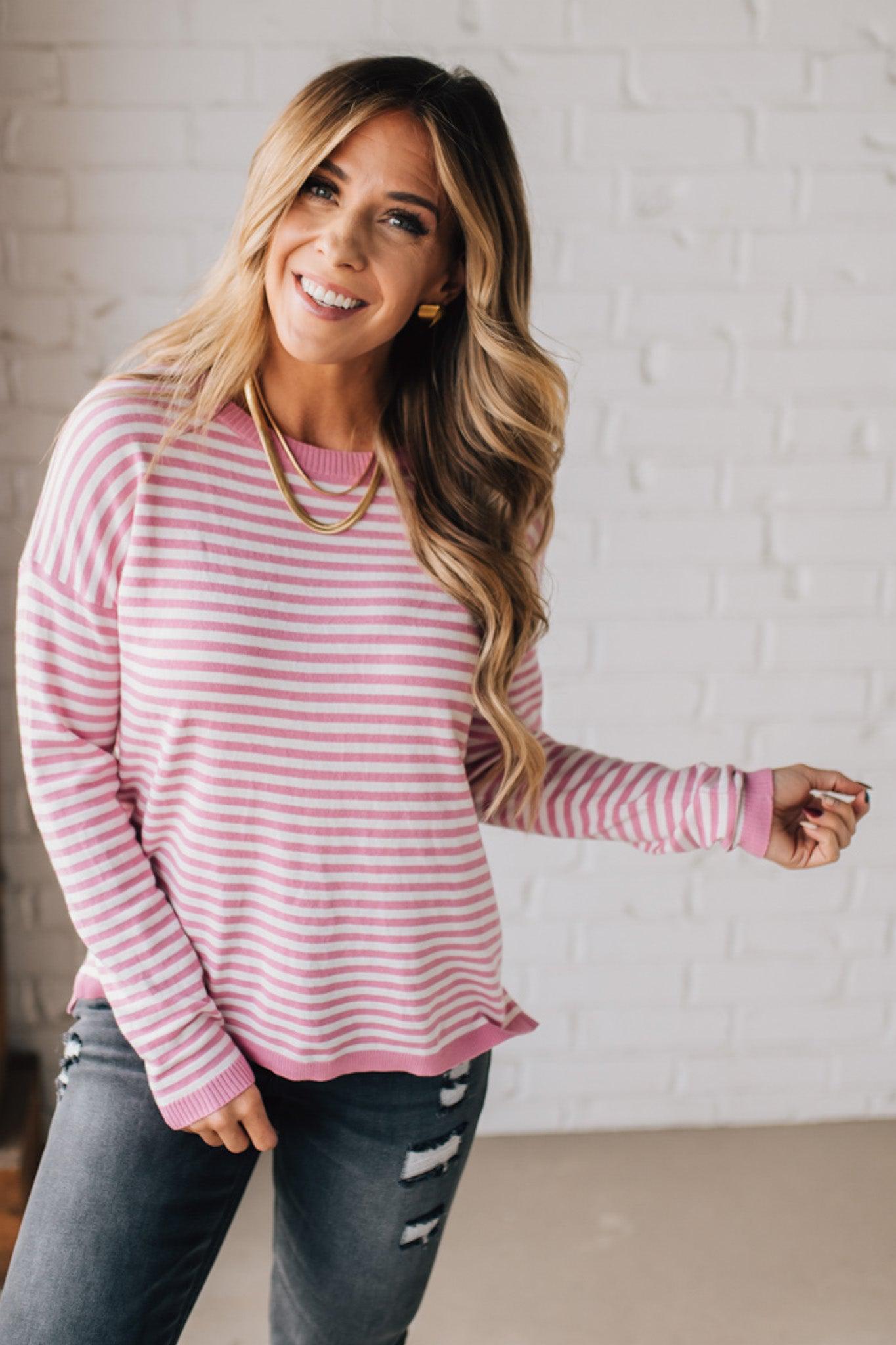 BLONDE WOMAN MODELING A LONG SLEEVE STRIPED LIGHTWEIGHT SWEATER WITH RIBBED SOLID COLORED NECKLINE AND SLEEVE CUFFS