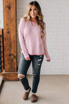 BLONDE WOMAN MODELING A LONG SLEEVE STRIPED LIGHTWEIGHT SWEATER WITH RIBBED SOLID COLORED NECKLINE AND SLEEVE CUFFS