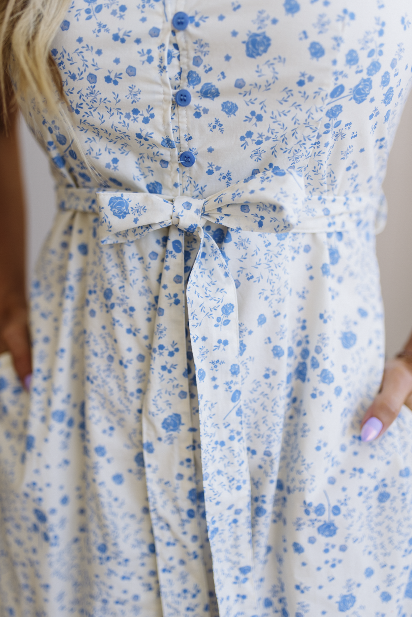Close-up of a floral dress with blue flowers on a white background