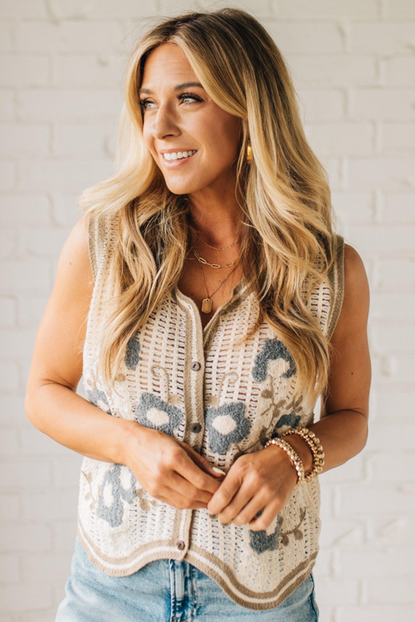 Blonde woman wearing a Floral Embroidery Patch Crochet Sweater Vest in cream, with mocha and dusty blue weave.