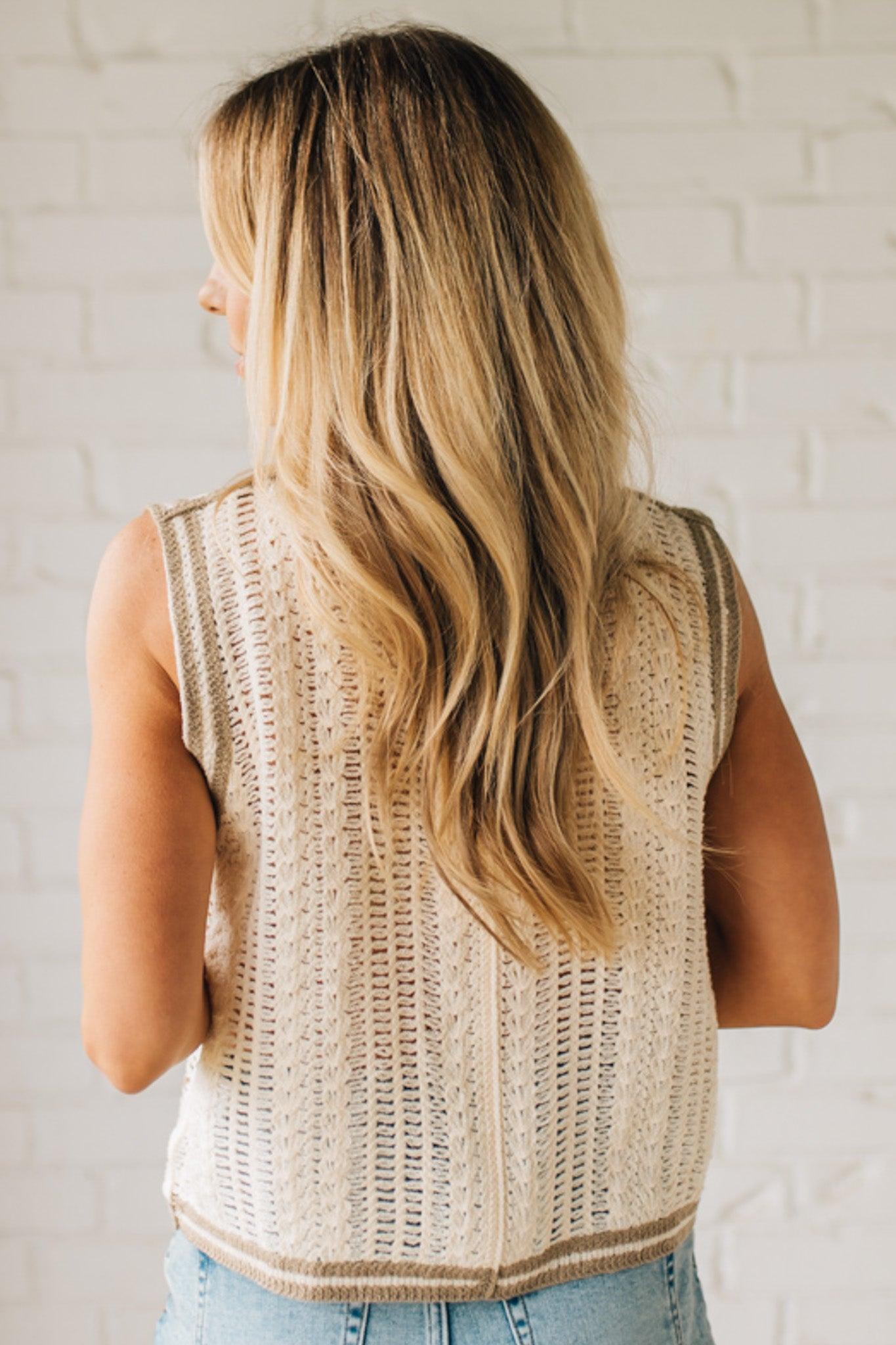 Blonde woman wearing a Floral Embroidery Patch Crochet Sweater Vest in cream, with mocha and dusty blue weave.