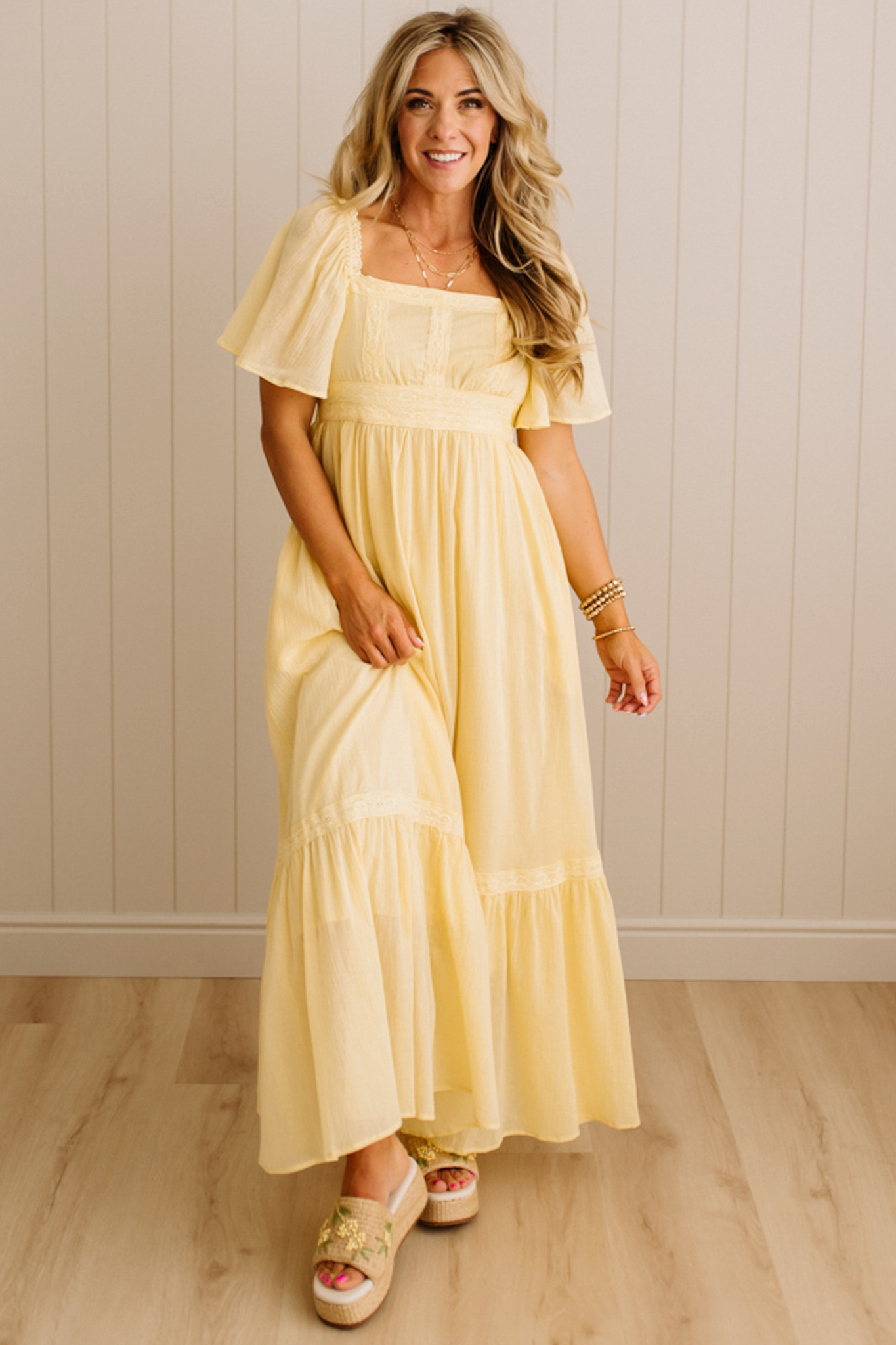Blonde Woman Wearing a Lemon Yellow Lace Inset Flutter Sleeve Maxi Dress