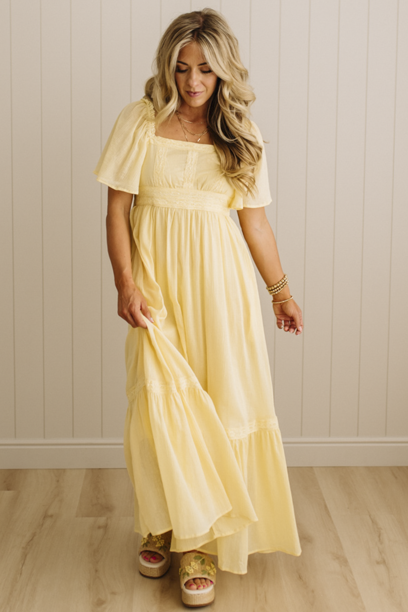Blonde Woman Wearing a Lemon Yellow Lace Inset Flutter Sleeve Maxi Dress