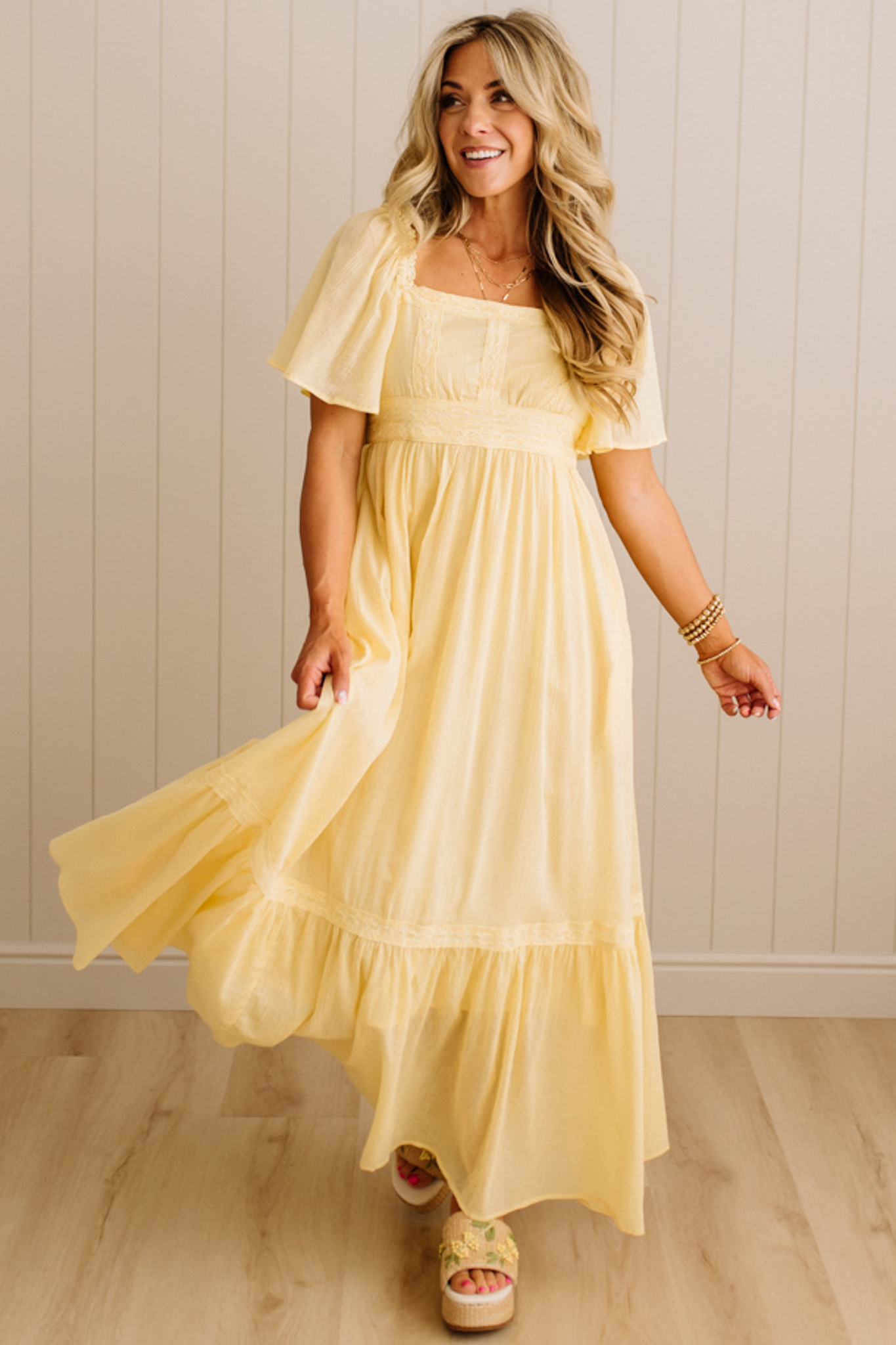Blonde Woman Wearing a Lemon Yellow Lace Inset Flutter Sleeve Maxi Dress