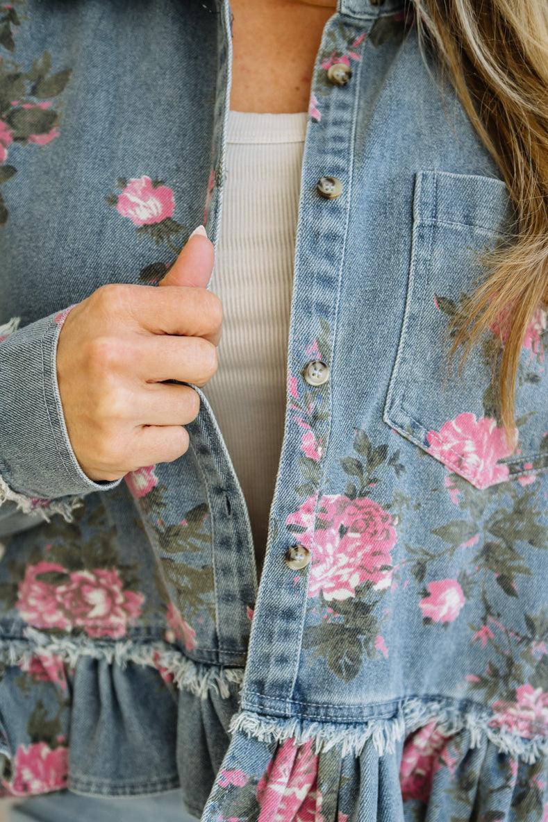 Denim jacket with floral patterns worn by a person