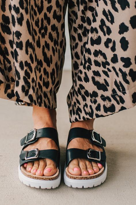 Women's Chunky Two Strap Sandal in black faux leather and white sole.