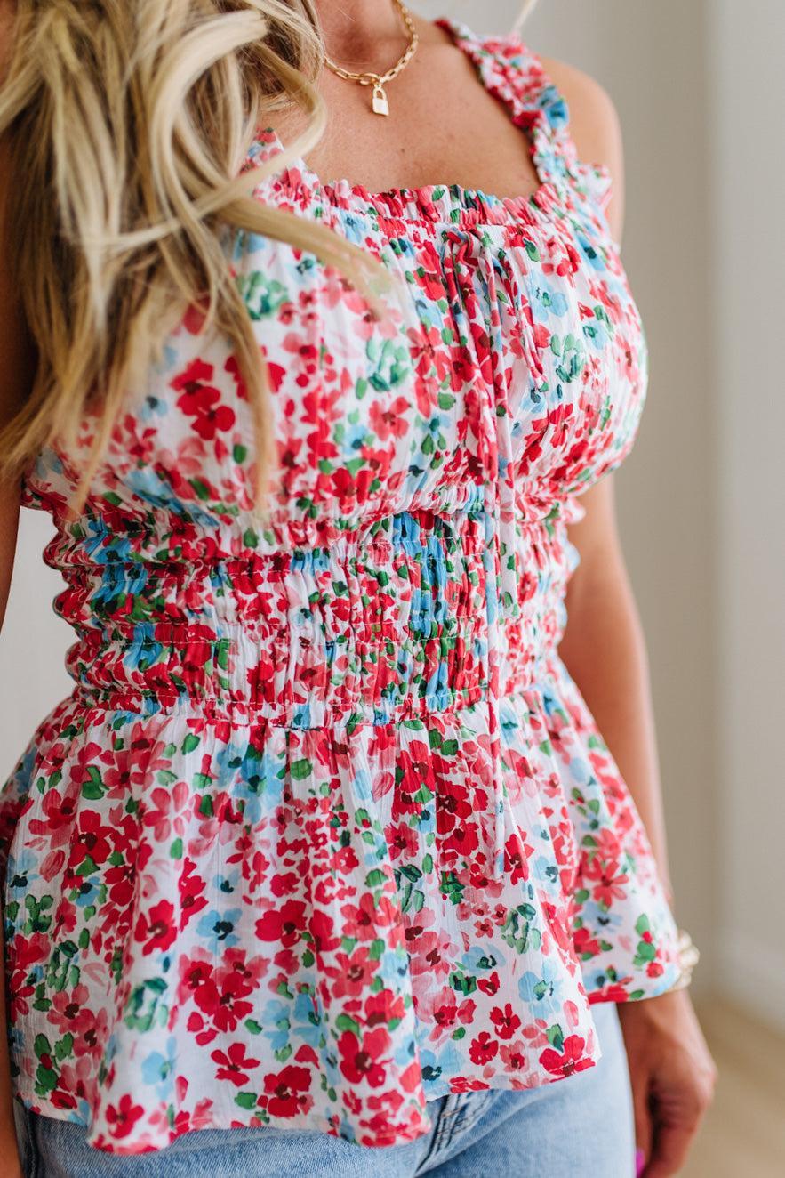 Woman wearing a floral top with a blurred background