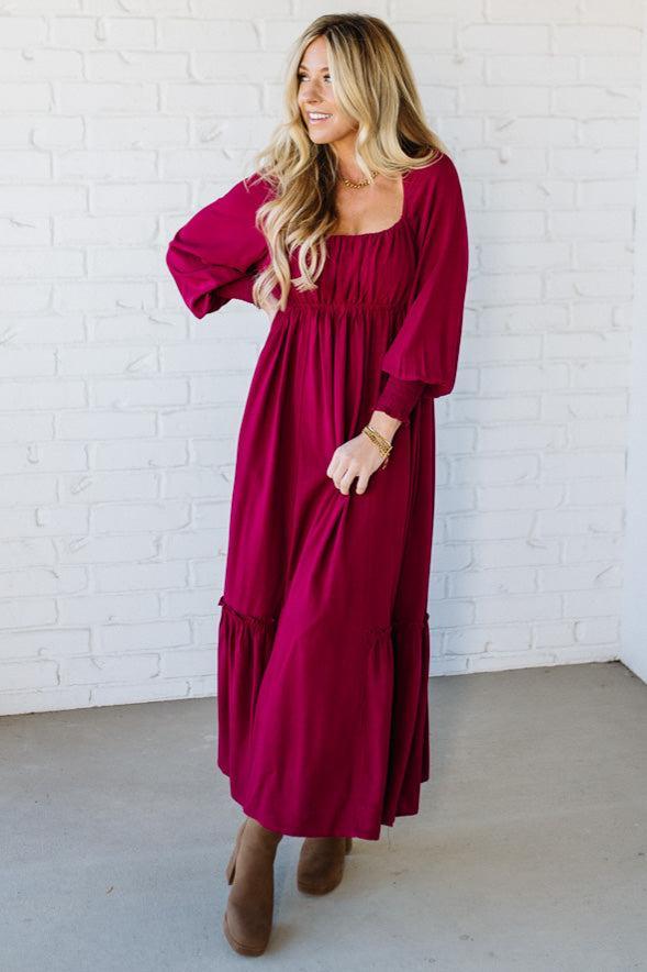 Blonde Woman Wearing a Gathered Long Sleeve Maxi Dress in the color Cherry Merlot.