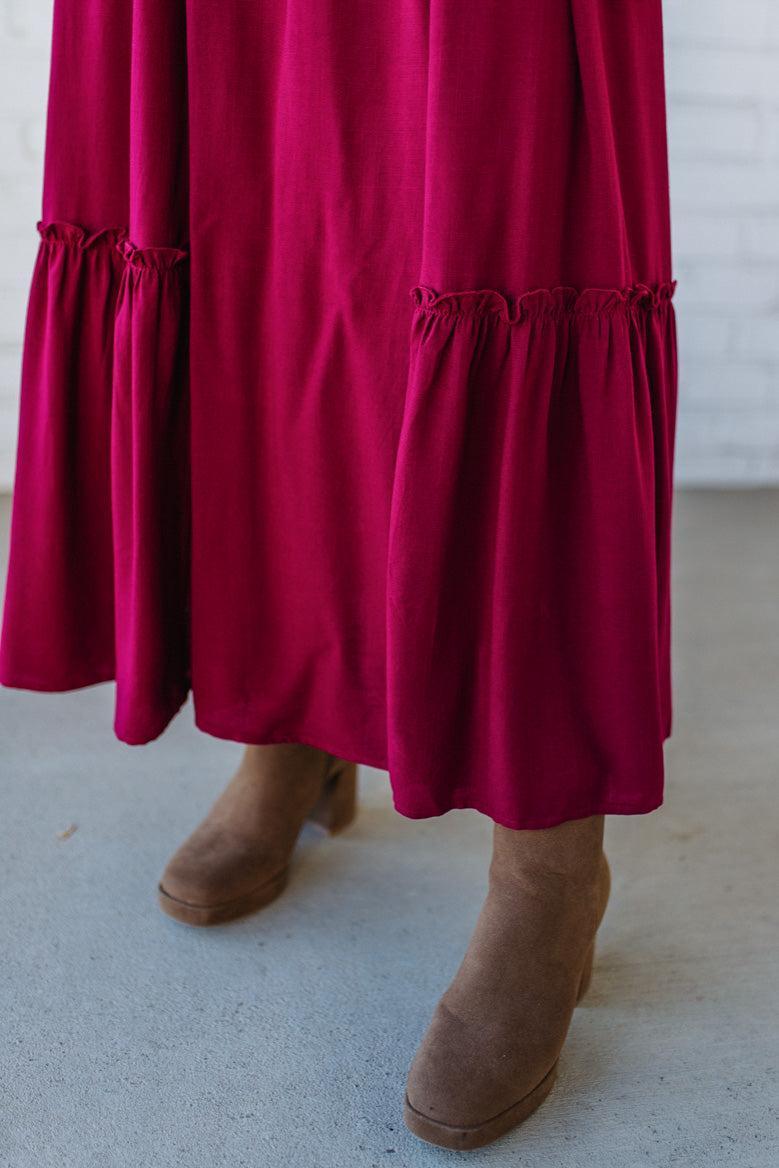 Blonde Woman Wearing a Gathered Long Sleeve Maxi Dress in the color Cherry Merlot.