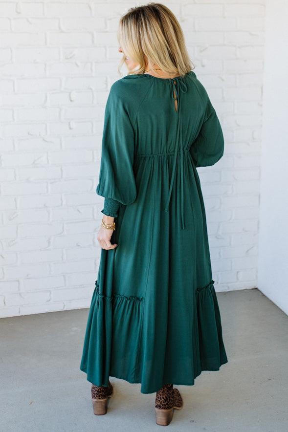 Blonde Woman Wearing a Gathered Long Sleeve Maxi Dress in the color Deep Forest.