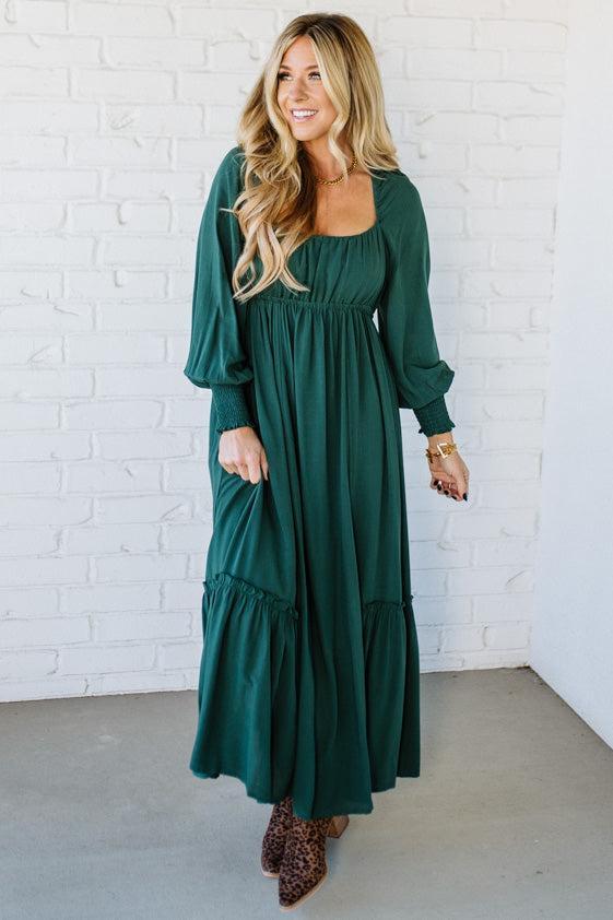 Blonde Woman Wearing a Gathered Long Sleeve Maxi Dress in the color Deep Forest.