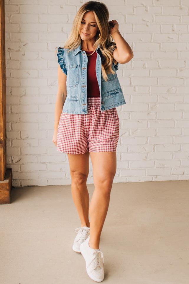 BLONDE WOMAN WEARING GINGHAM CHECK WOVEN BOXER SHORTS WITH SIDE POCKETS.