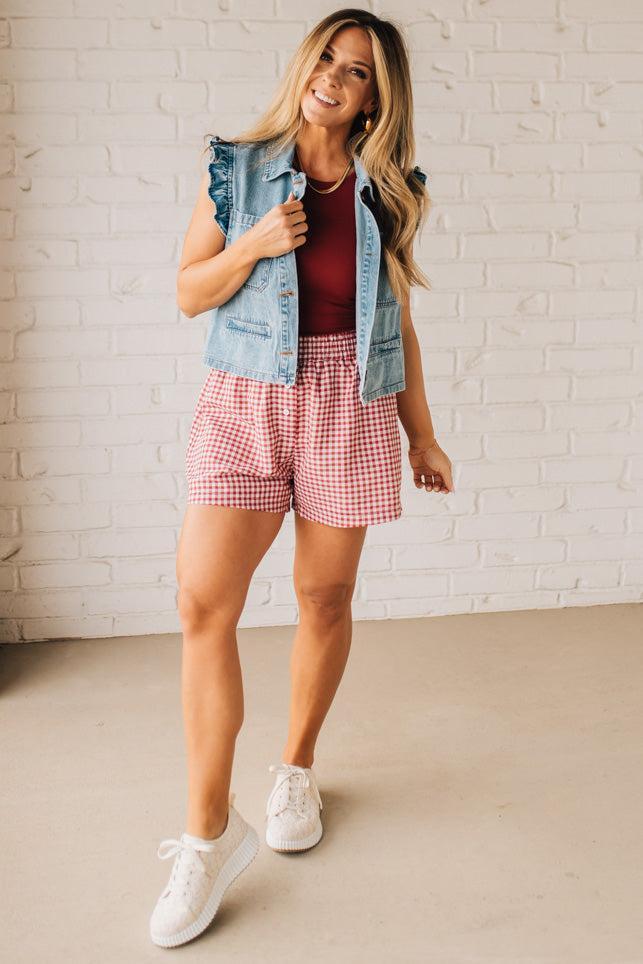BLONDE WOMAN WEARING GINGHAM CHECK WOVEN BOXER SHORTS WITH SIDE POCKETS.