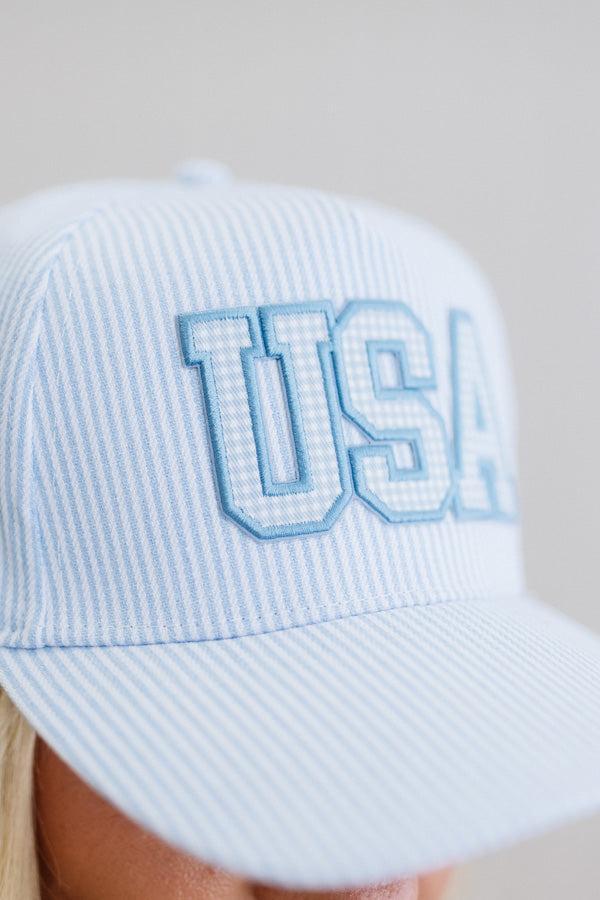 Light blue striped cap with 'USA' text on a neutral background