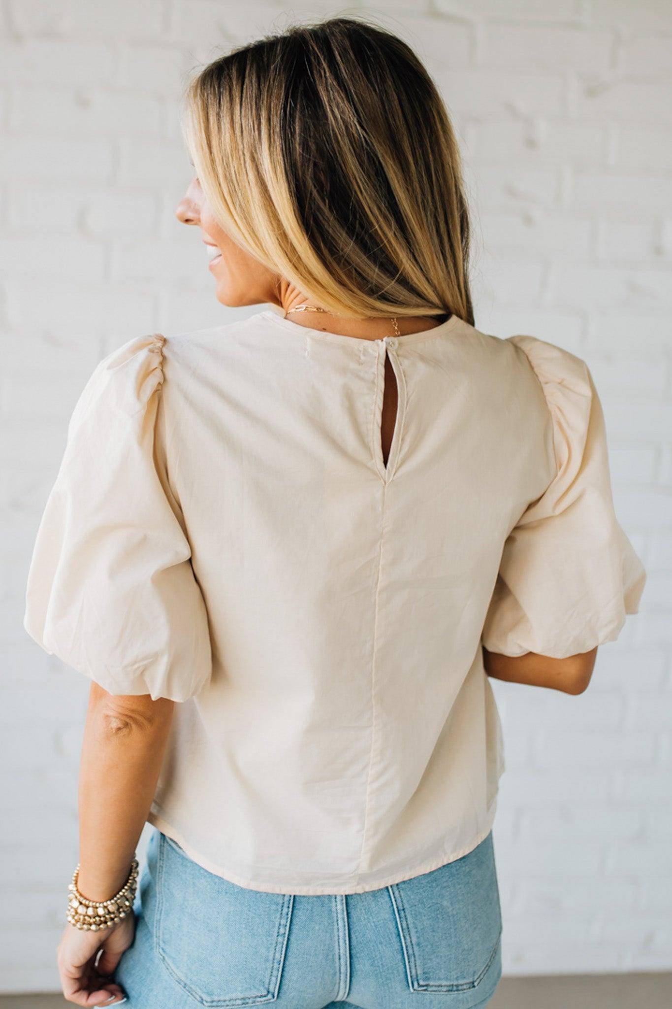 Blonde woman wearing a Mix Media Sequin Crochet Bodice Woven Blouse in cream.