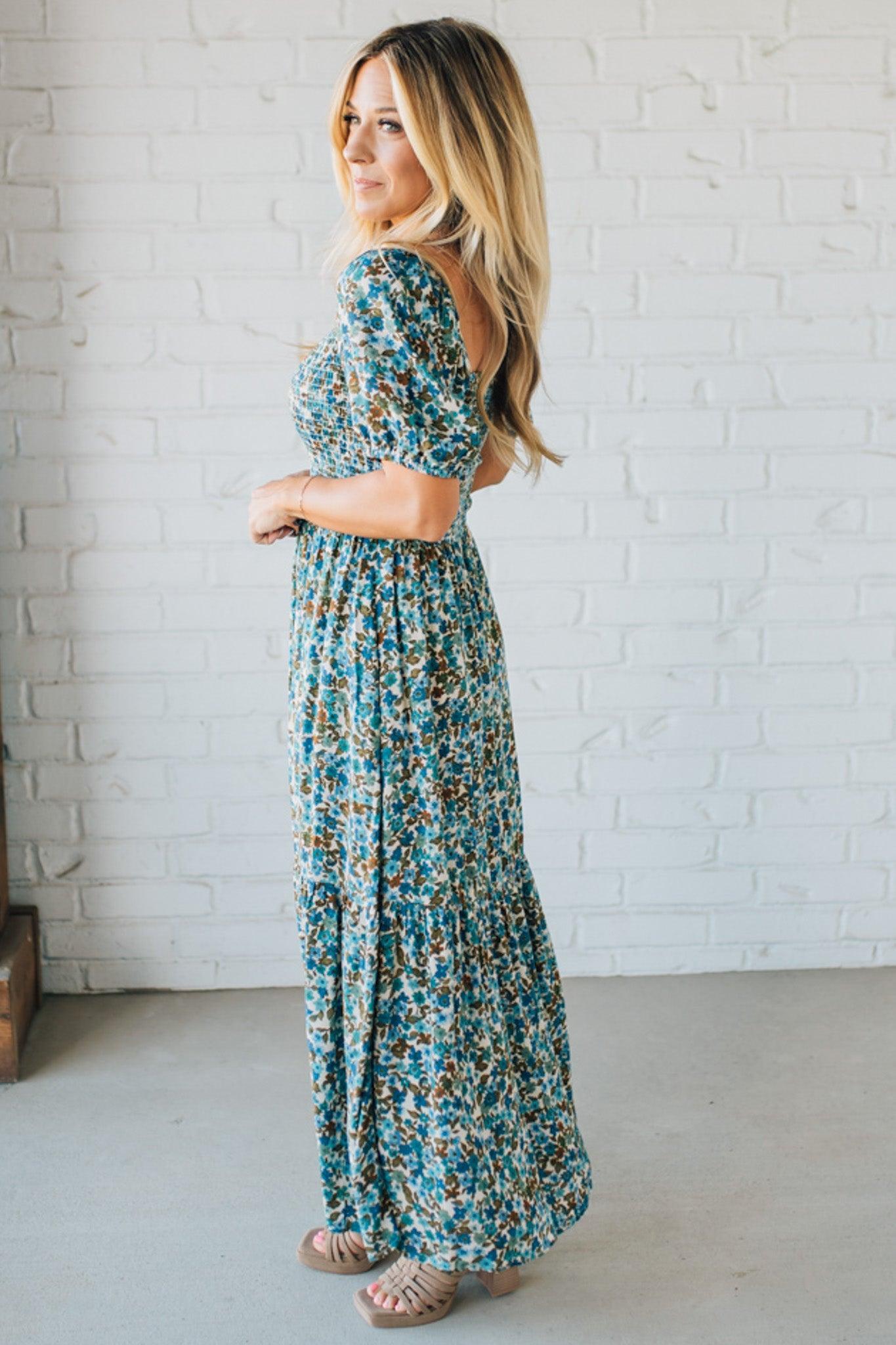 Blonde Woman Wearing A Floral Print Smocked Bodice Tiered Midi Dress.