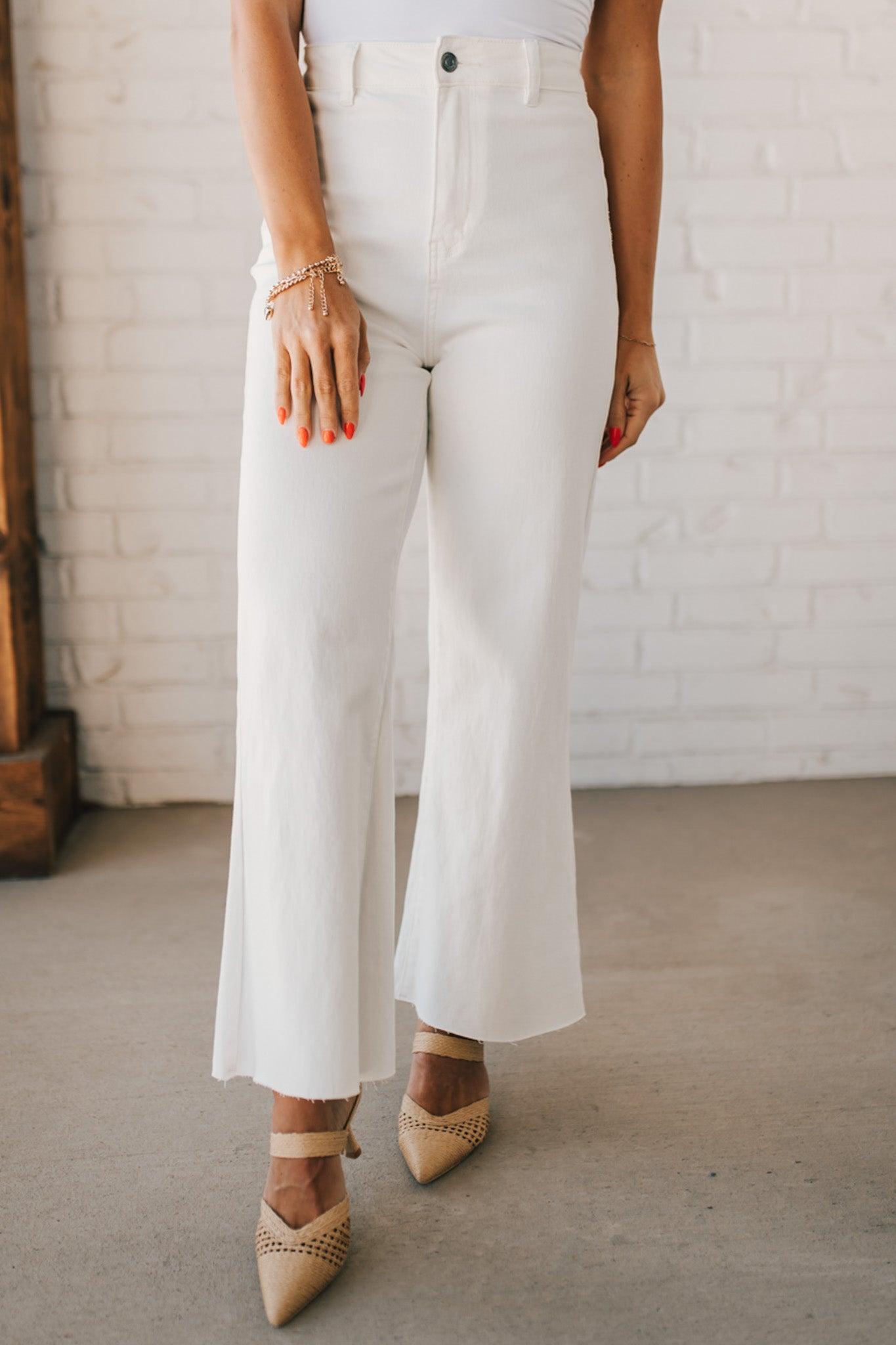 High waist wide leg denim with scissor cut hem in crisp white.