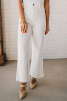 High waist wide leg denim with scissor cut hem in crisp white.