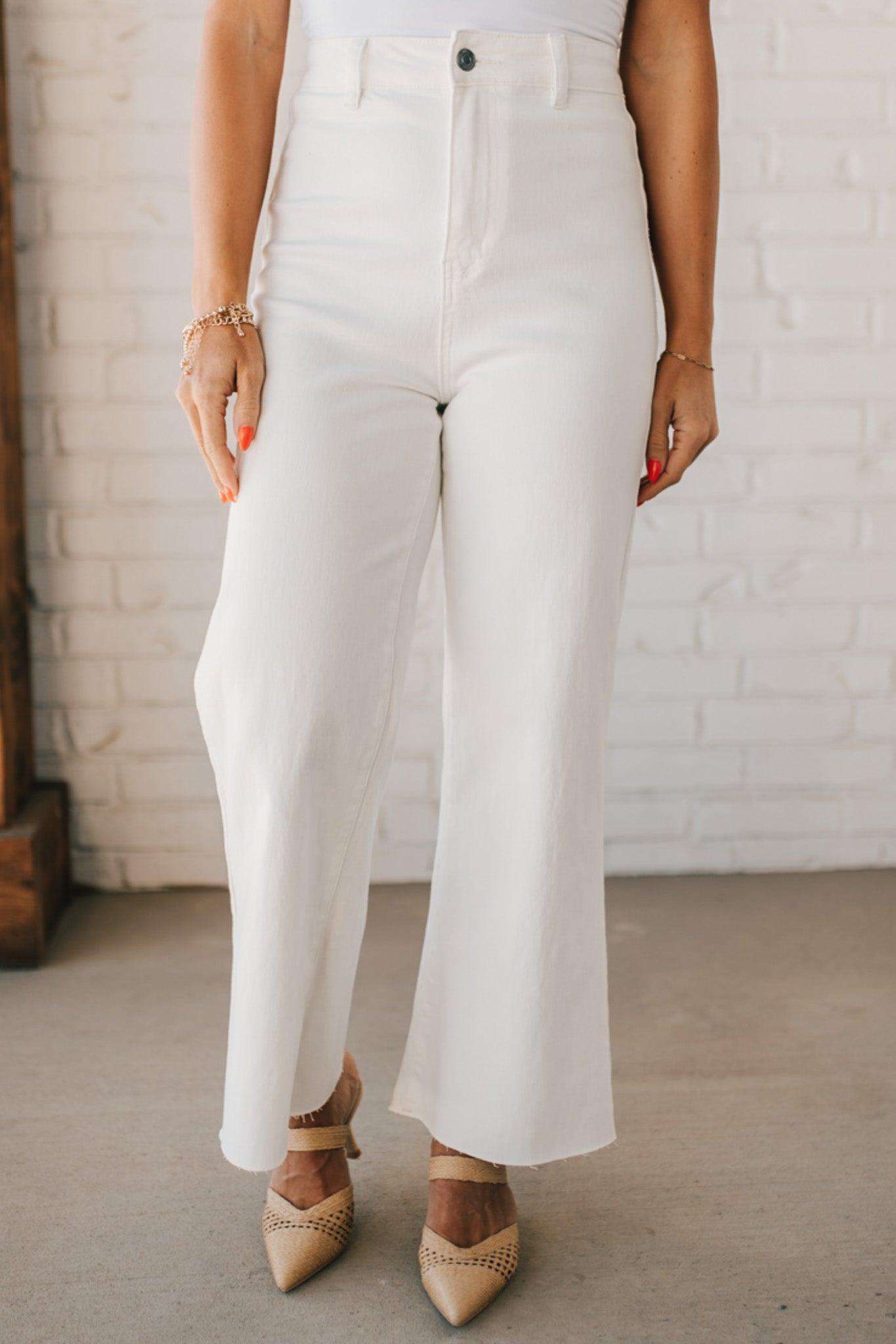 High waist wide leg denim with scissor cut hem in crisp white.