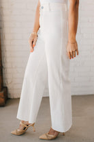 High waist wide leg denim with scissor cut hem in crisp white.