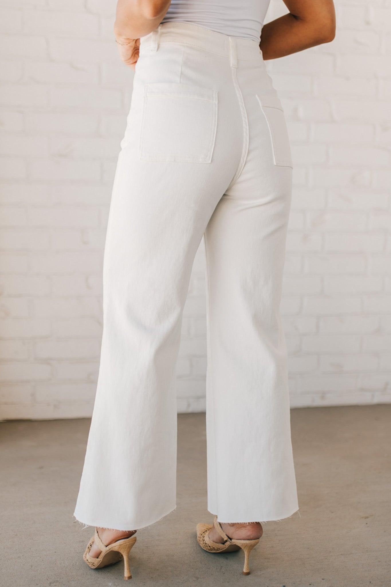 High waist wide leg denim with scissor cut hem in crisp white.