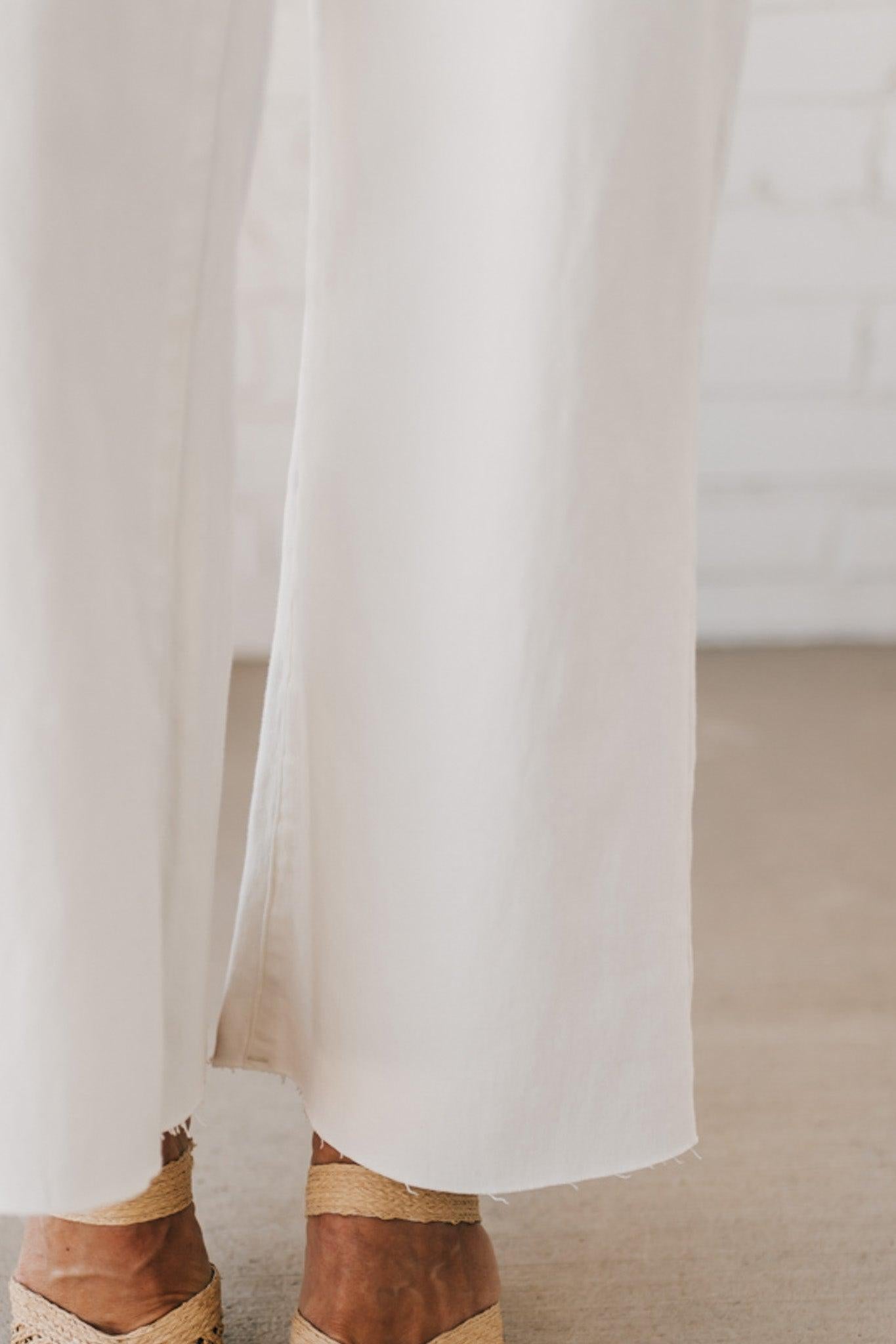 High waist wide leg denim with scissor cut hem in crisp white.