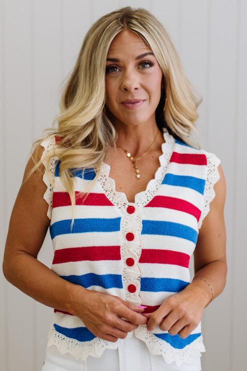 Woman wearing a red, white, and blue striped sleeveless top with lace details.