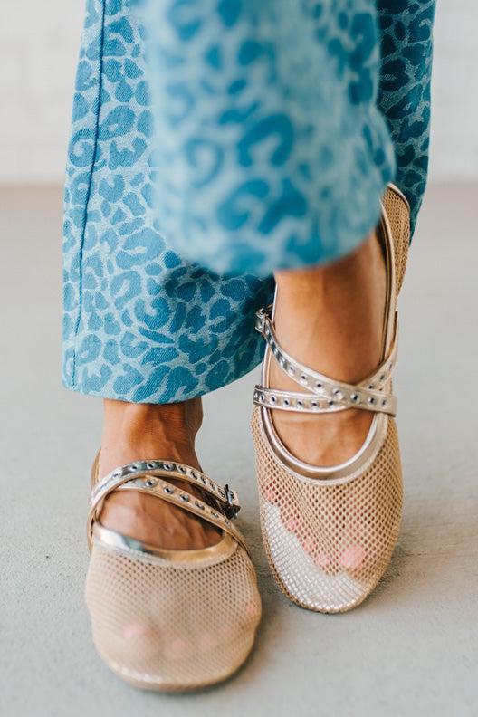 Women's gold flat sandals with a mesh outer, and double grommet lined fauze leather straps.