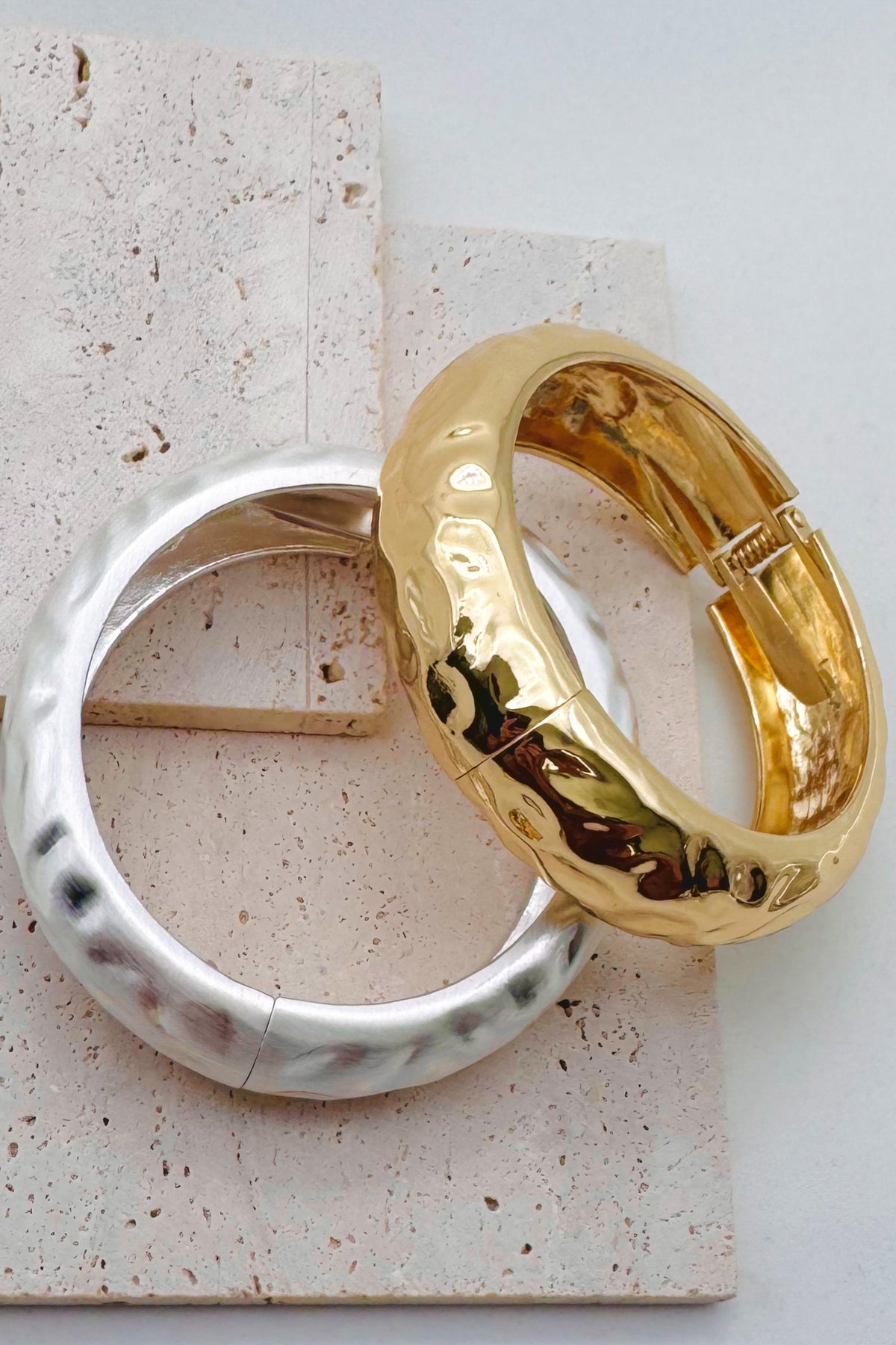 Pile of mixed metal bangle bracelets.