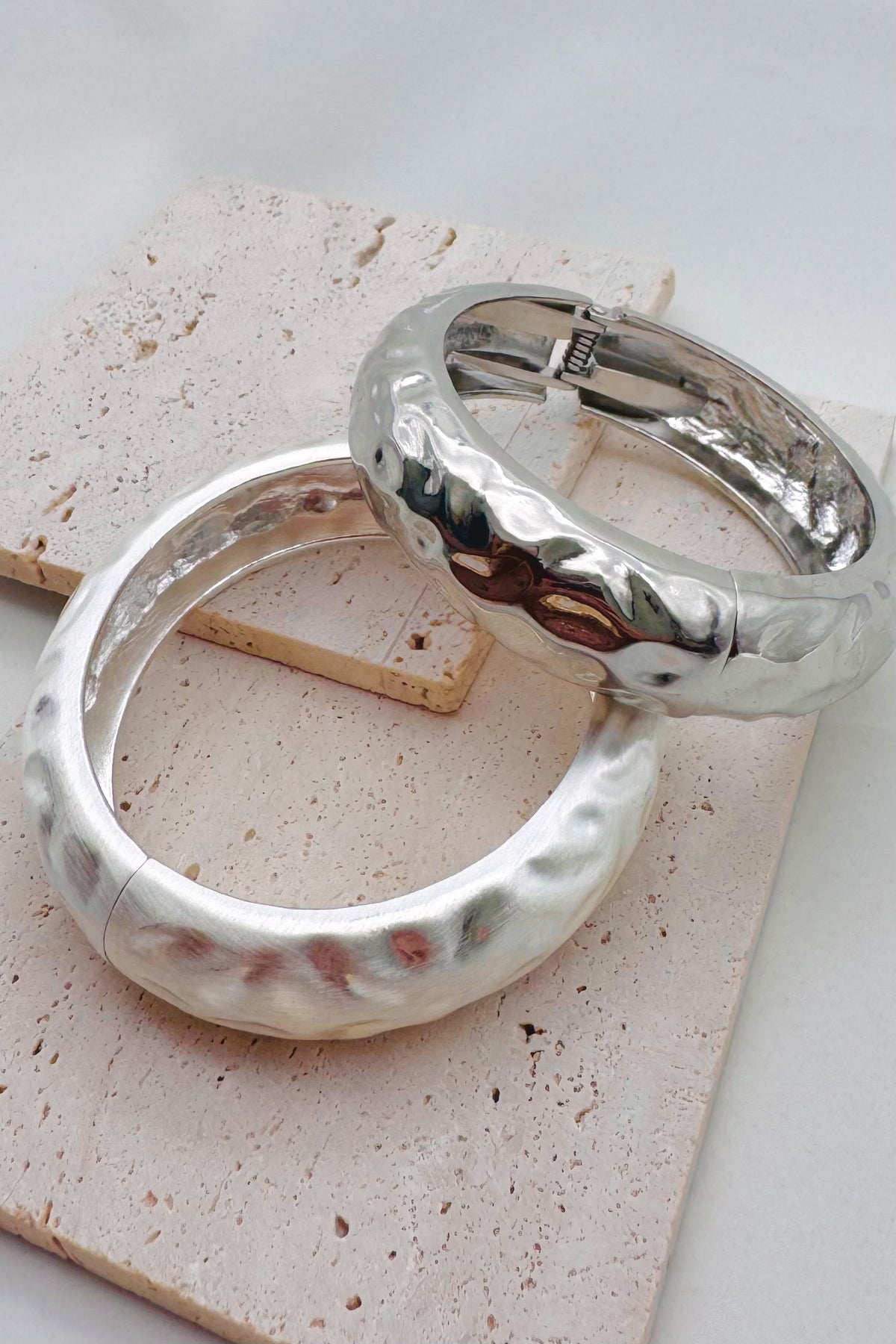 Pile of mixed metal bangle bracelets.