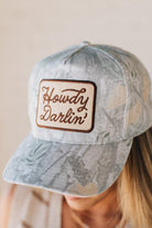 Blonde woman wearing a Howdy Darlin' Embroidery Patch Camo Trucker Hat.