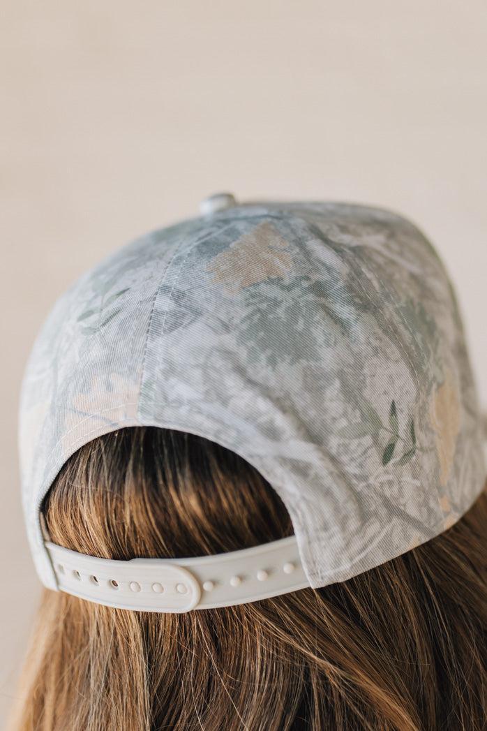 Blonde woman wearing a Howdy Darlin' Embroidery Patch Camo Trucker Hat.