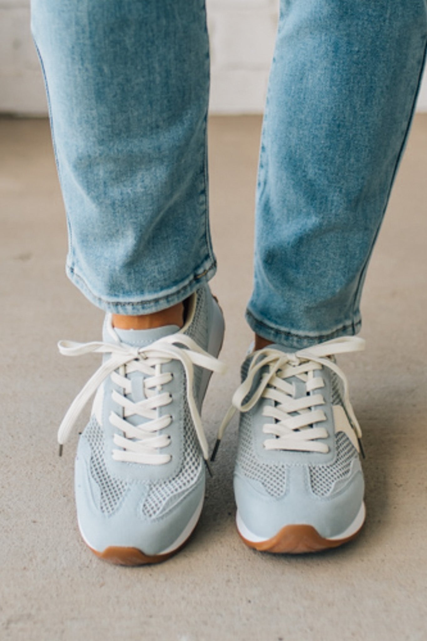 Women's Light Blue Mesh Sneakers with Cream Laces and Accents.