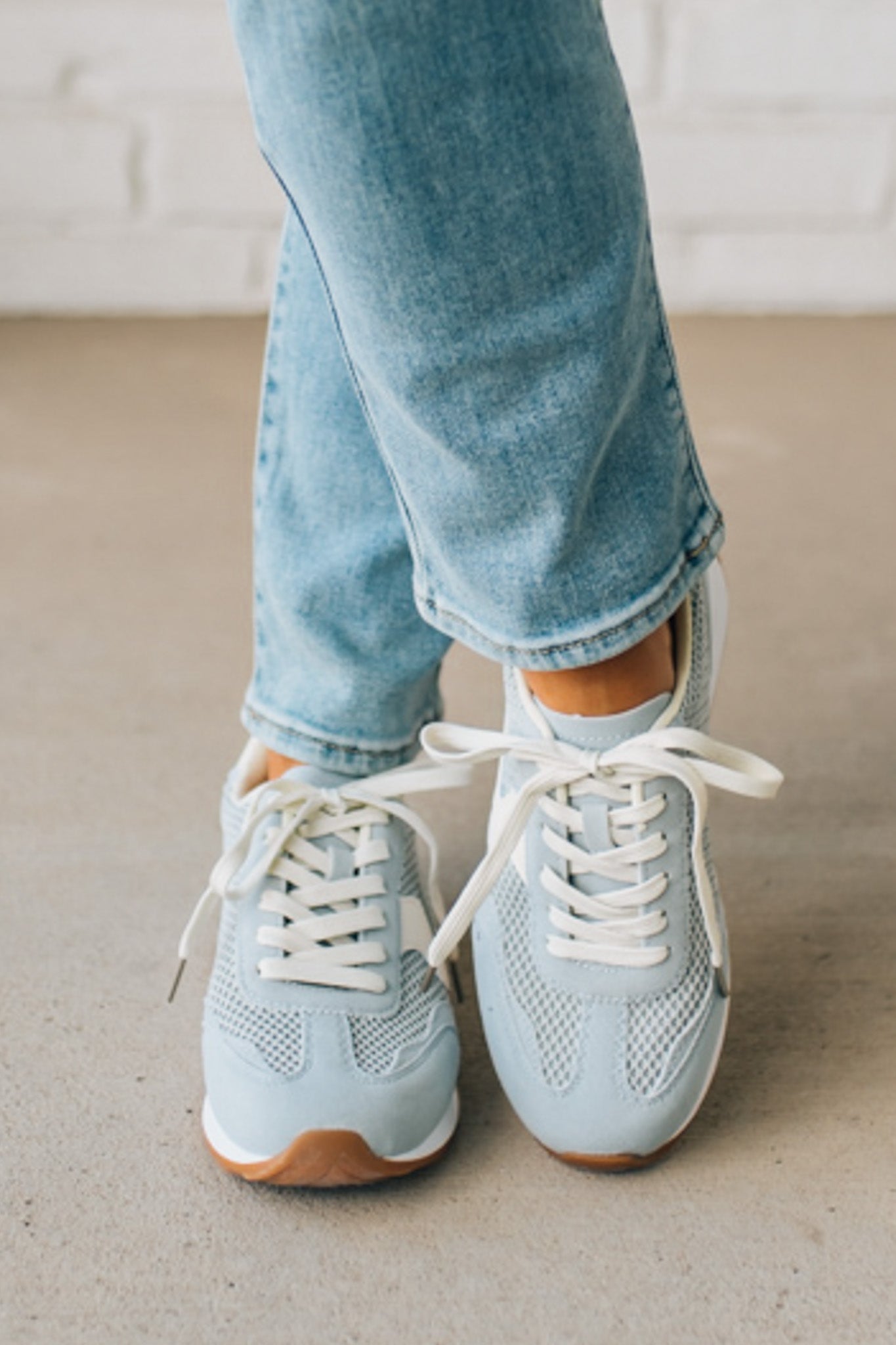 Women's Light Blue Mesh Sneakers with Cream Laces and Accents.