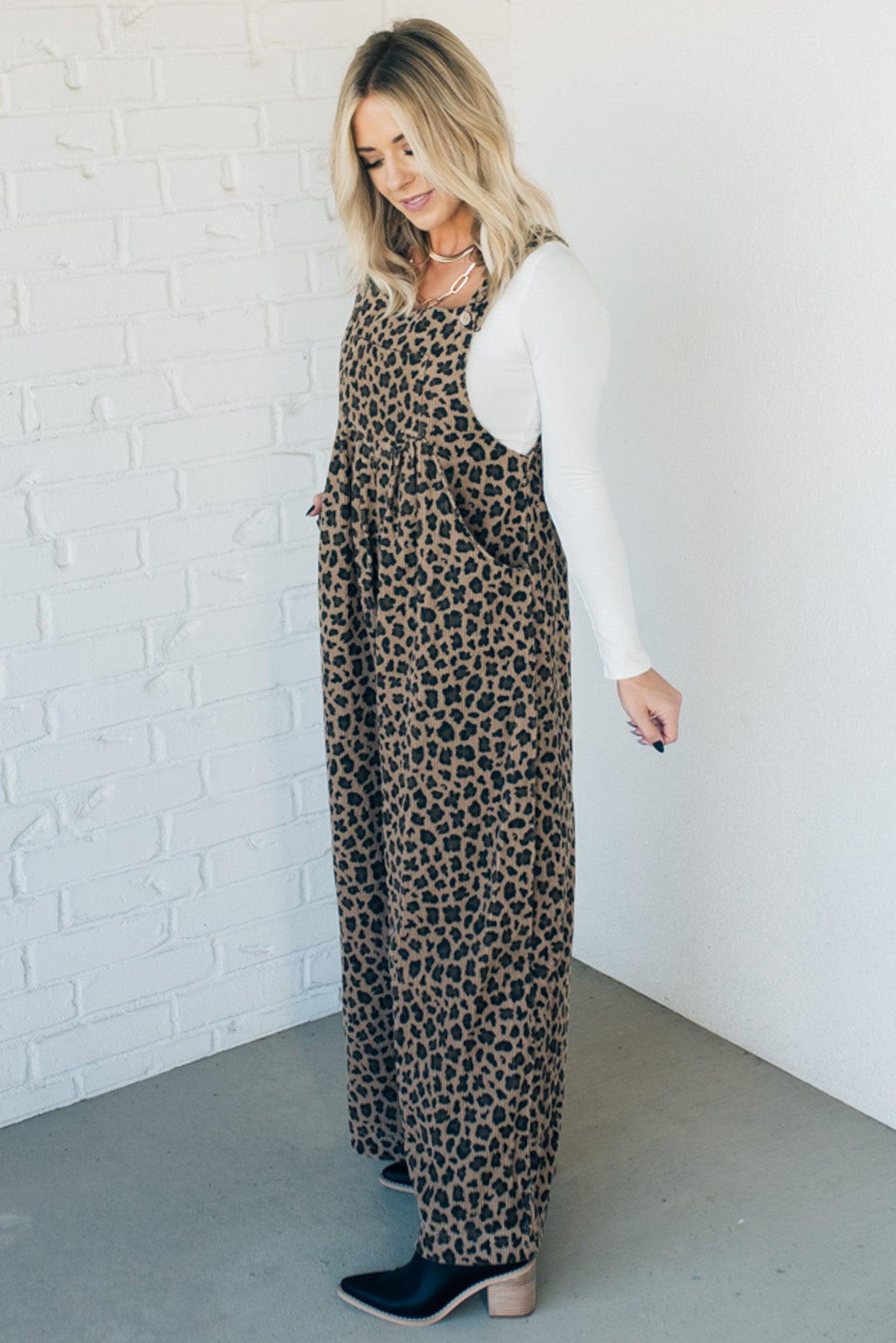 Blonde woman wearing wide leg overalls with all over leopard print and corduroy texture.