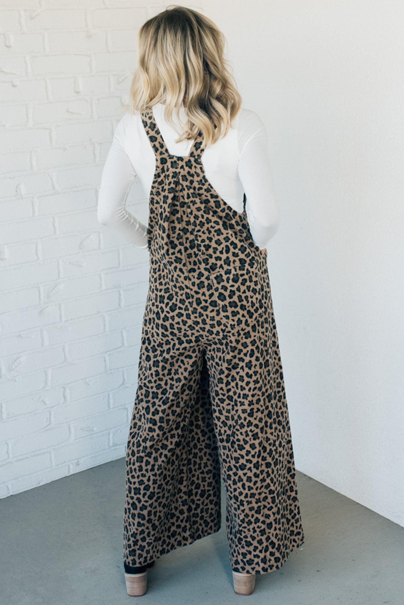 Blonde woman wearing wide leg overalls with all over leopard print and corduroy texture.