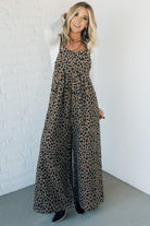 Blonde woman wearing wide leg overalls with all over leopard print and corduroy texture.