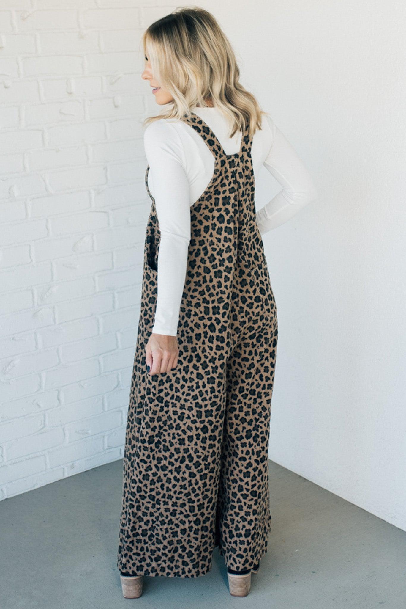 Blonde woman wearing wide leg overalls with all over leopard print and corduroy texture.
